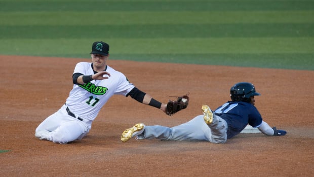 SF Giants prospect Tyler Fitzgerald attempts to tag D.J. Burt. (2021)